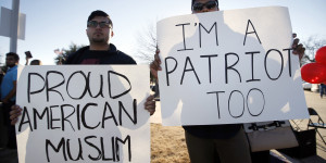 Sharjeel Hassan, left, and Yusuf  Alwar,, both of Richardson, Texas, holds signs as they stand with supporters outside the Curtis Culwell Center, Saturday, Jan. 17, 2015, in Garland, Texas. A muslim conference against terror and hate was scheduled at the event center. (AP Photo/Tony Gutierrez)