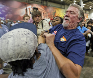 A supporter of Republican presidential hopeful Donald Trump scuffles with a protestor during a rally in Richmond, Va., Wednesday, Oct. 14, 2015.  (AP Photo/Steve Helber)