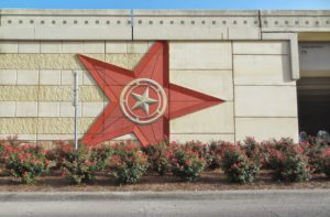 Texas Freeway road art - Lone Star State on abutment wall with landscaping June 2014 I-10 pic