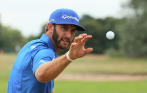 HOYLAKE, ENGLAND - JULY 20:  Dustin Johnson of the United States reaches for a golf ball on the practice ground during the final round of The 143rd Open Championship at Royal Liverpool on July 20, 2014 in Hoylake, England.  (Photo by Mike Ehrmann/Getty Images)