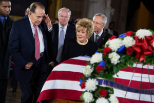 UNITED STATES - DECEMBER 20:  Former Sen. Bob Dole, R-Kan., salutes the casket of the late Sen. Daniel Inouye, D-Hawaii, as his body lies in state in the Capitol rotunda, as Dole's wife, former Sen. Elizabeth Dole, R-N.C., looks on.  Bob Dole and Inouye knew each other since they were recovering from World War II battle wounds.  Dole was assisted to the casket saying "I wouldn't want Danny to see me in a wheelchair."  (Photo By Tom Williams/CQ Roll Call)
