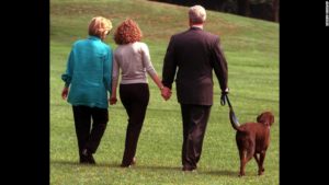 President Clinton, his daughter Chelsea, center, and wife Hillary walk with Buddy Tuesday, Aug. 18, 1998, from the White House toward a helicopter as they depart for vacation enroute to Martha's Vineyard, Mass. (AP Photo/Roberto Borea)